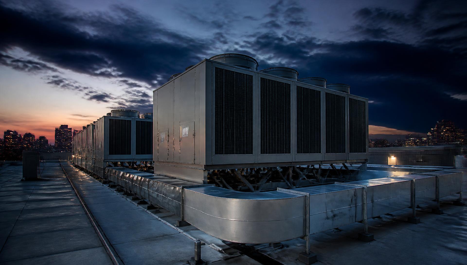 Commercial rooftop HVAC equipment on a New York building at dusk